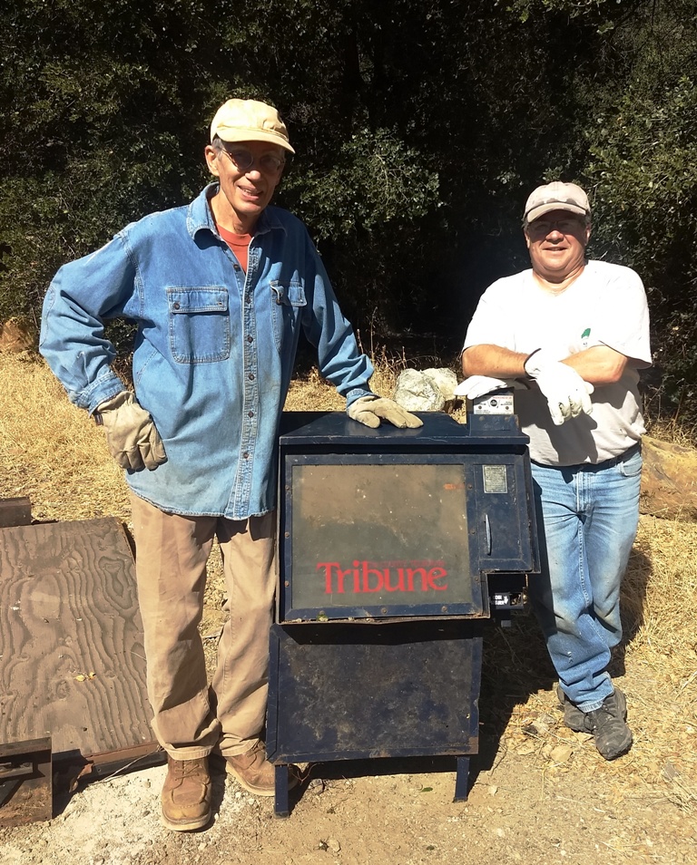 John Goers and Mike Orvis pull the Tribune dispenser out of Atascadero Creek!